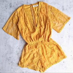 Mustard yellow Reverse romper size small. NWT